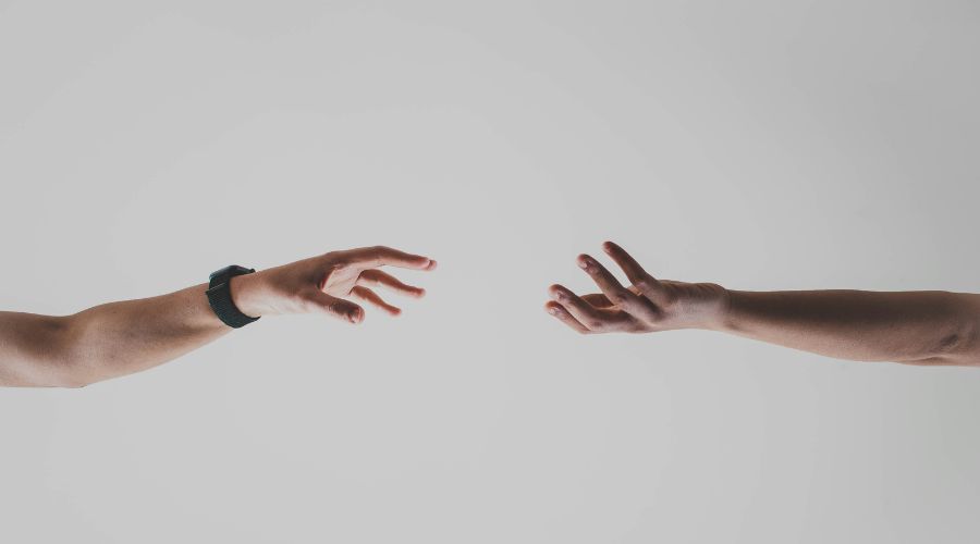 Outreach: Two hands reaching for each other